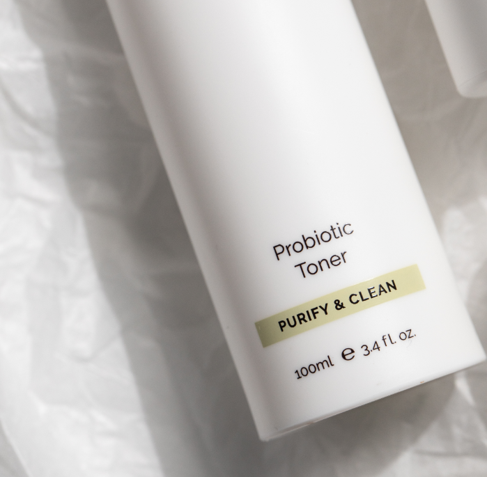A probiotic toner is kept on a white paper-type surface