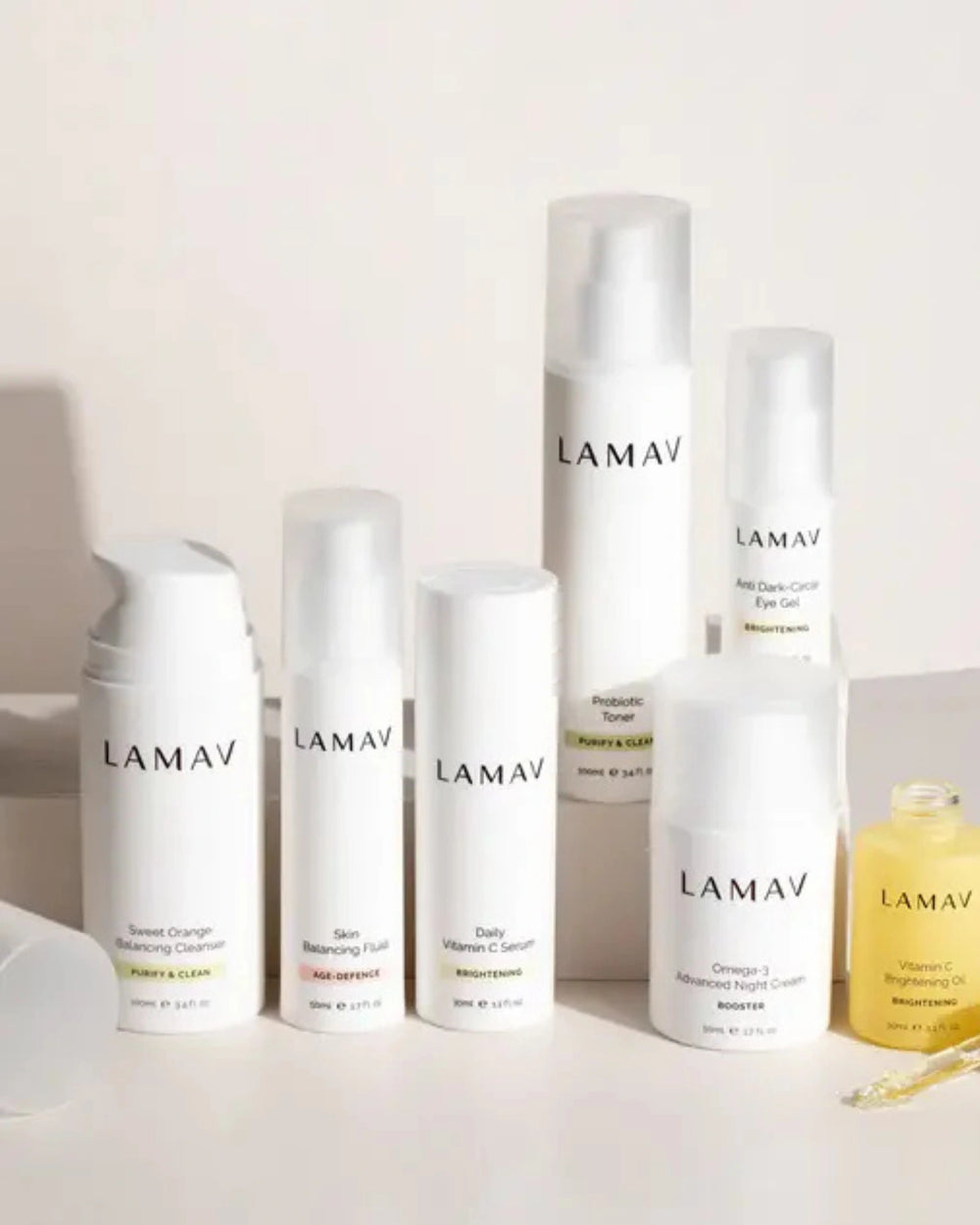 Age Defence Complete Skincare Collection for Oily Combination Skin by LAMAV — seven skincare bottles lined up on a stone podium, front view | balancing routine