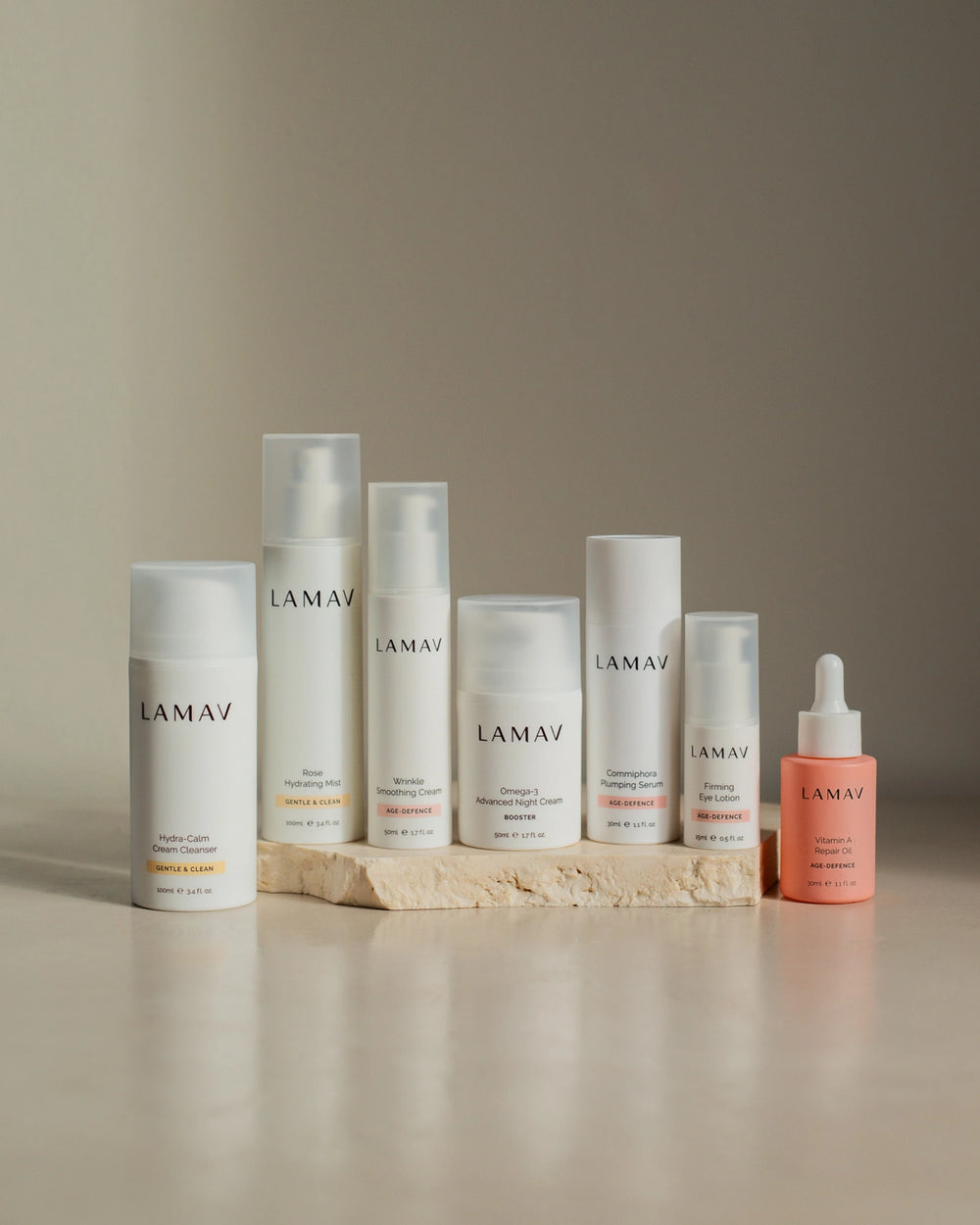Age Defence Complete Skincare Collection by LAMAV — seven anti-aging skincare bottles on a stone podium, front view | firming routine