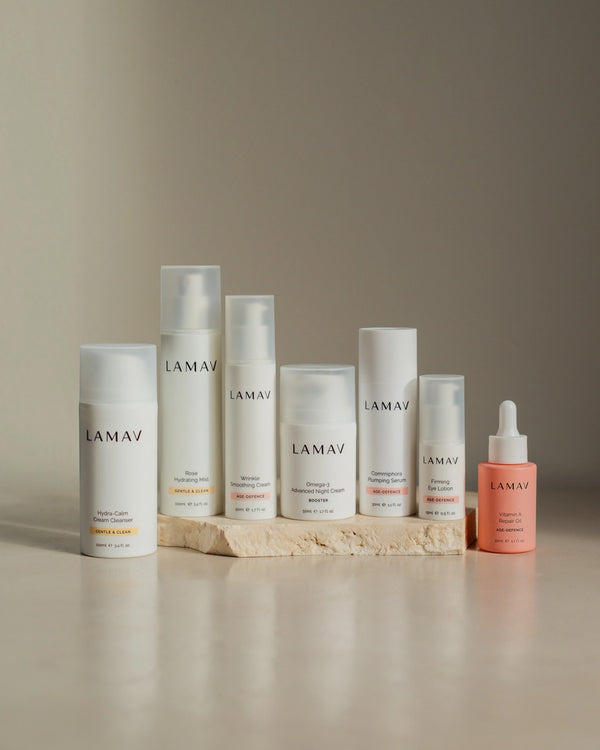 Age-Defence Complete Collection by LAMAV — 7 skincare bottles on a textured stone slab | Complete routine for sensitive skin