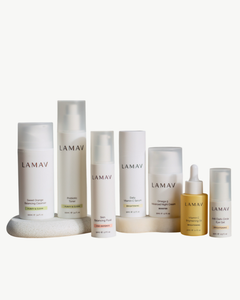 Age Defence Complete Skincare Collection for Oily Combination Skin by LAMAV — seven skincare bottles lined up on a stone podium, front view | balancing routine