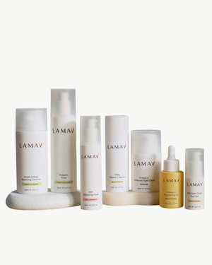 Age Defence Complete Skincare Collection for Oily Combination Skin by LAMAV — seven skincare bottles lined up on a stone podium, front view | balancing routine