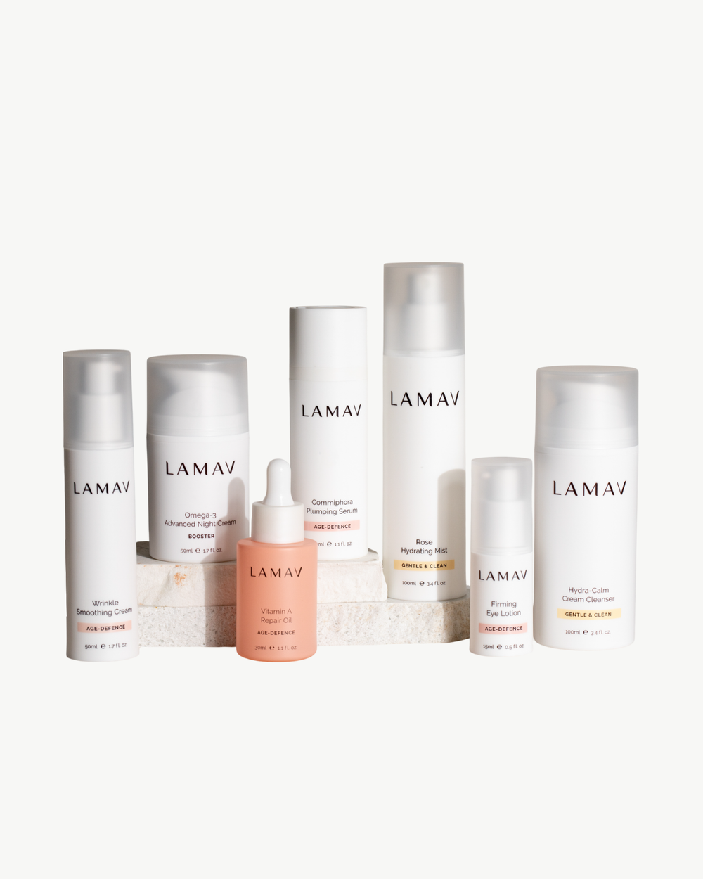 Age Defence Complete Skincare Collection by LAMAV — seven anti-aging skincare bottles on a stone podium, front view | firming routine