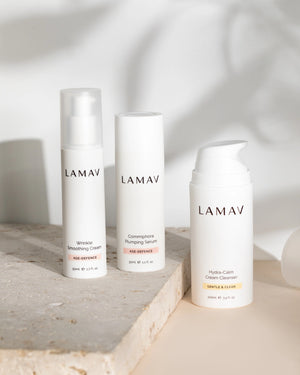Age-Defence Essentials by LAMAV — 3 upright bottles on a rough stone slab with leaf shadow | Firm and plump