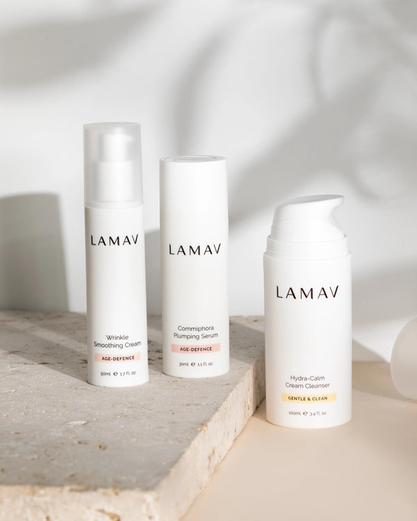 Age-Defence Essentials by LAMAV — 3 upright bottles on a rough stone slab with leaf shadow | Firm and plump