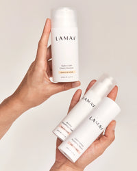 Age-Defence Essentials by LAMAV — two hands holding 3 white skincare bottles | Smooth and rejuvenate skin