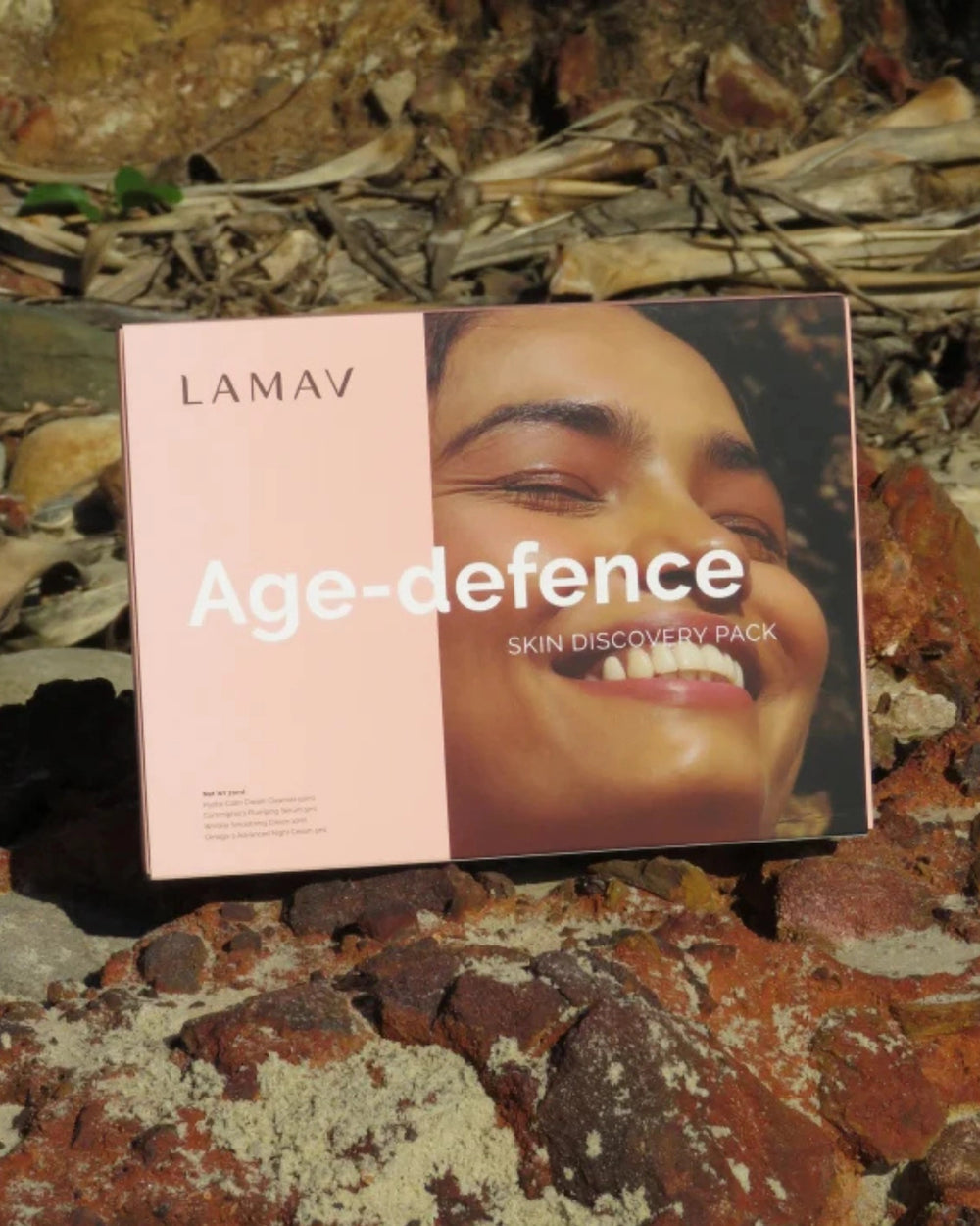 Age-Defence Pack by LAMAV — 4 skincare tubes on a wavy coaster next to pink box | Discover smoother, younger-looking skin