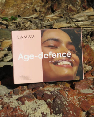 Age-Defence Pack by LAMAV — Pink product box resting outdoors on natural rocks | Start your organic anti-aging journey
