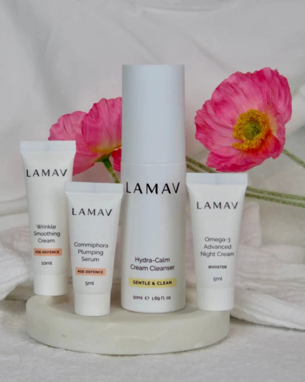 Age-Defence Pack by LAMAV — 4 skincare mini products standing with pink poppies | Natural anti-aging skincare routine