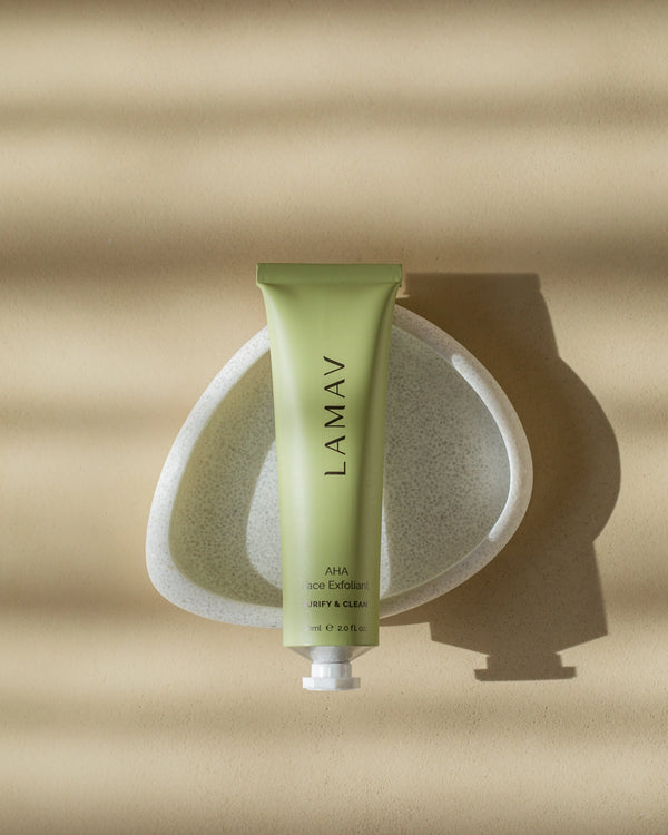 AHA Face Exfoliant by LAMAV — green tube resting in a white textured dish | Purify and clean your skin