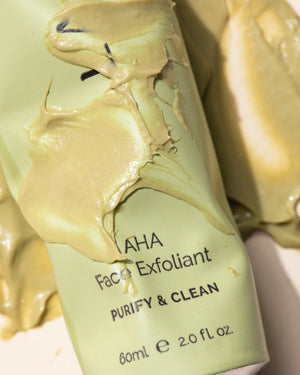 AHA Face Exfoliant by LAMAV — tube covered in thick creamy green product smear | Deeply cleanse and gently exfoliate