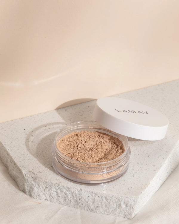 Anti-Ageing Mineral Foundation SPF15 by LAMAV — open jar of powder resting on white stone | Buildable anti-aging coverage