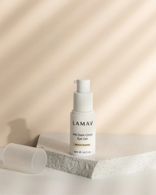 Anti Dark-Circle Eye Gel by LAMAV — open bottle on a speckled stone under striped light | Refresh and illuminate eyes