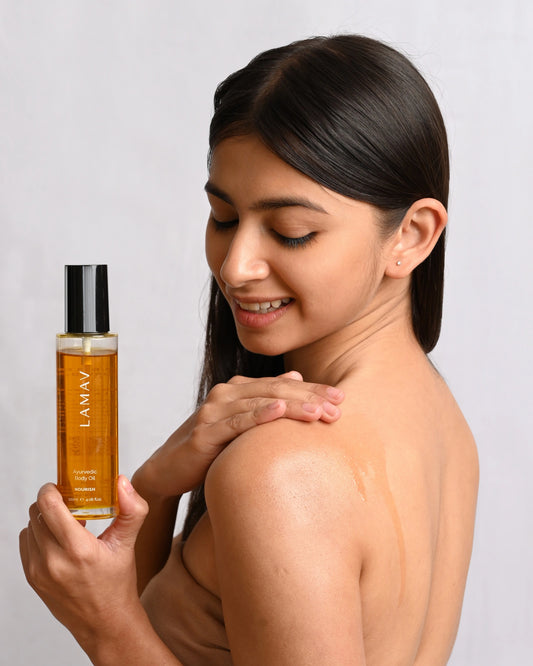 Ayurvedic Body Oil Nourish by LAMAV — woman applying oil to her bare shoulder | Deeply moisturizes and soothes skin