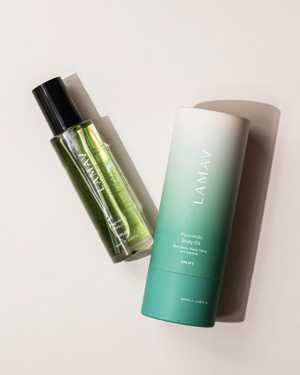 Ayurvedic Body Oil Uplift by LAMAV — bottle and teal packaging lying flat on a table | Deeply hydrating organic oil