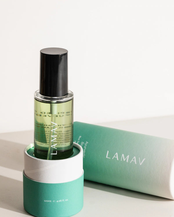 Ayurvedic Body Oil Uplift by LAMAV — bottle in packaging base with lid lying next to it | Promotes a healthy glow