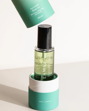 Ayurvedic Body Oil Uplift by LAMAV — bottle sitting in its open tube with lid lifted | Revitalizes dry skin
