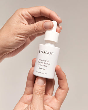 Bakuchiol 4% Booster by LAMAV — hands holding the 30ml white dropper bottle | gentle anti-aging skincare