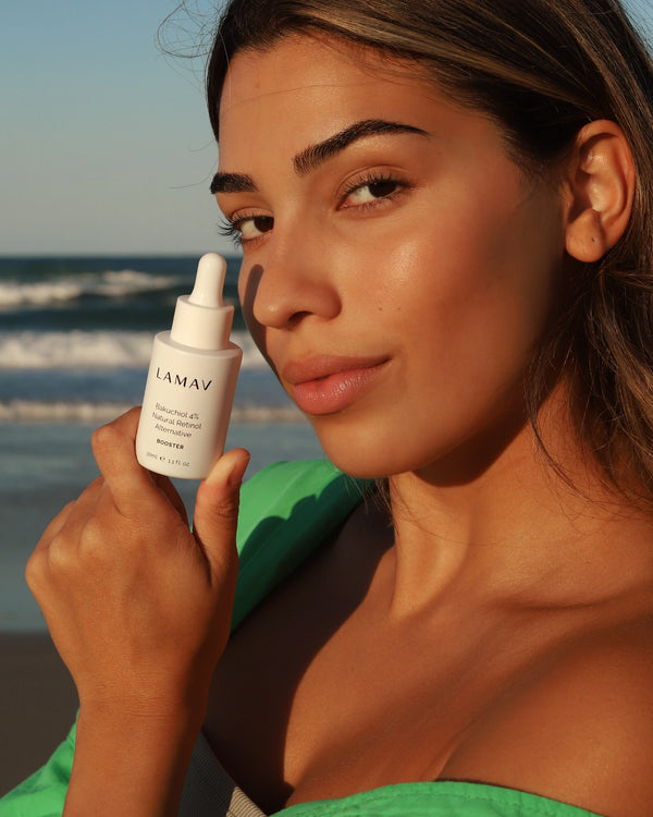 Bakuchiol 4% Booster by LAMAV — woman holding dropper bottle at the beach | promotes glowing youthful skin
