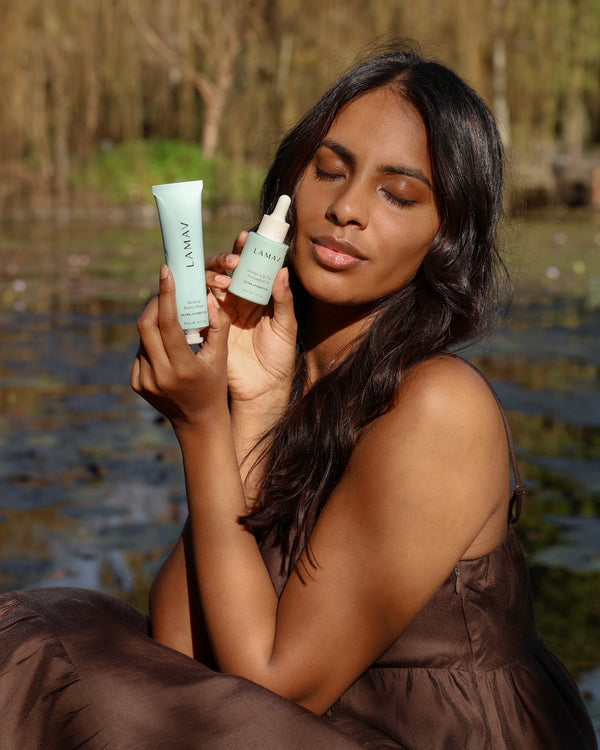 Beauty Sleep Mask by LAMAV — woman by a pond holding the tube and a serum bottle | repairs skin overnight