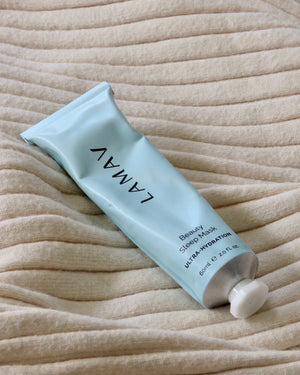Beauty Sleep Mask by LAMAV — blue tube lying on a ribbed beige blanket | Wake up to a glowing complexion