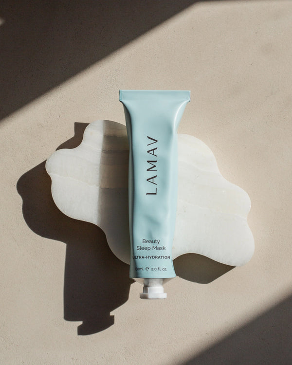 Beauty Sleep Mask by LAMAV — blue tube resting on a wavy white stone | Plumps and restores skin while you sleep
