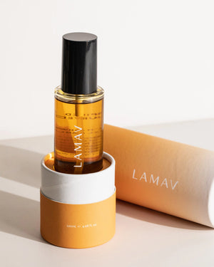 Body Oil Trio by LAMAV — amber Nourish bottle in its base packaging with lid lying next to it | Deeply moisturize skin