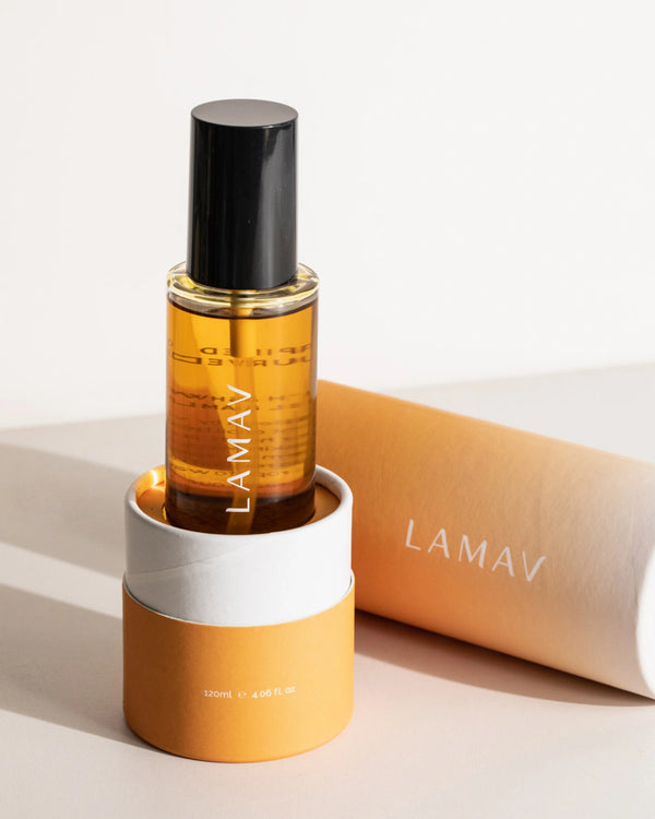 Body Oil Trio by LAMAV — amber Nourish bottle in its base packaging with lid lying next to it | Deeply moisturize skin