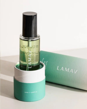 Body Oil Trio by LAMAV — green Uplift bottle in its base packaging with lid lying next to it | Invigorate and brighten