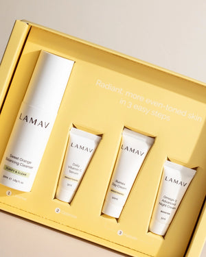 Brightening Discovery Pack by LAMAV — closed yellow box with open cleanser and three tubes | glowing skin routine