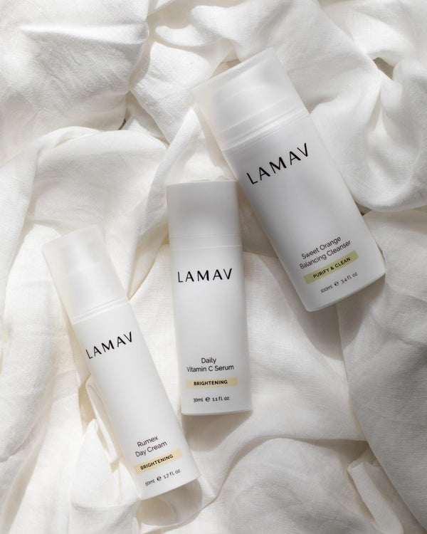 Brightening Essentials Set by LAMAV — three bottles resting on soft white linen fabric | Gentle organic skincare