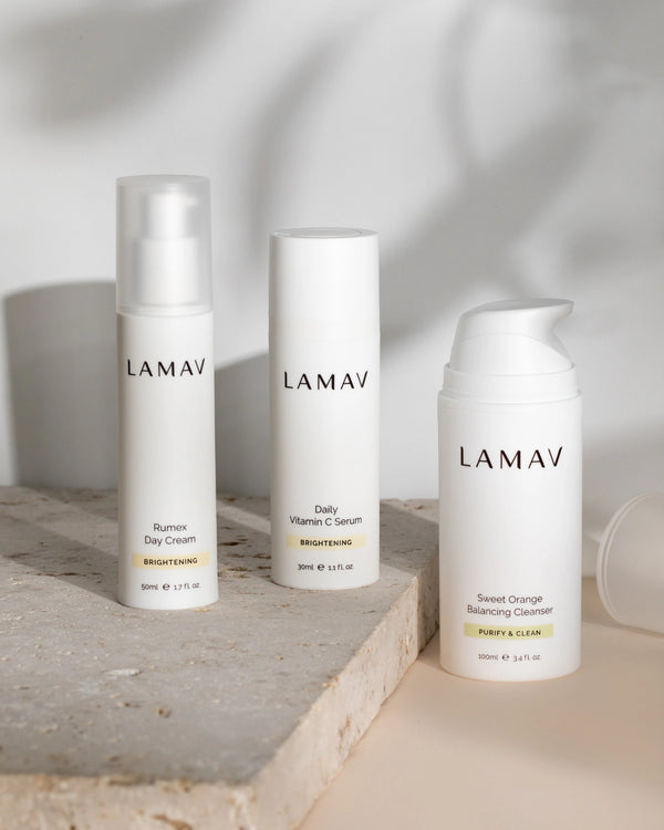 Brightening Essentials by LAMAV — three bottles on a stone block with shadows | promotes a glowing even complexion