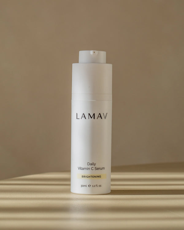 Daily Vitamin C Serum by LAMAV — white bottle standing on a table in striped sunlight | Potent antioxidant protection