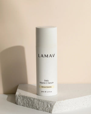 Daily Vitamin C Serum by LAMAV — bottle standing on a textured white stone | Defends against free radicals