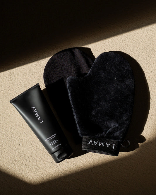 Exfoliating Mitt by LAMAV — black mitt next to self tanning lotion tube | Preps skin for an even tan
