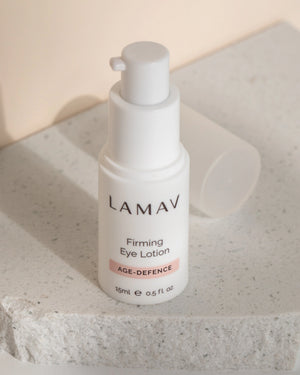 Firming Eye Lotion by LAMAV — 15ml bottle standing on a textured white stone slab | Natural organic age defence