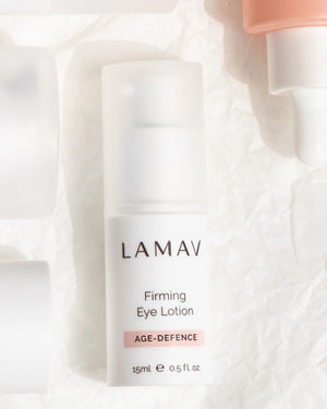 Firming Eye Lotion by LAMAV — bottle resting flat on crushed white paper | Firms and lifts the delicate eye contour