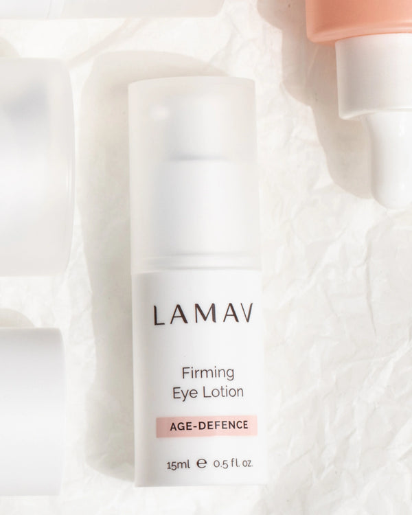 Firming Eye Lotion by LAMAV — bottle resting flat on crushed white paper | Firms and lifts the delicate eye contour