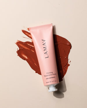 Firming Treatment Mask by LAMAV — pink tube resting on a thick smear of red clay mask | Purifies and firms the complexion