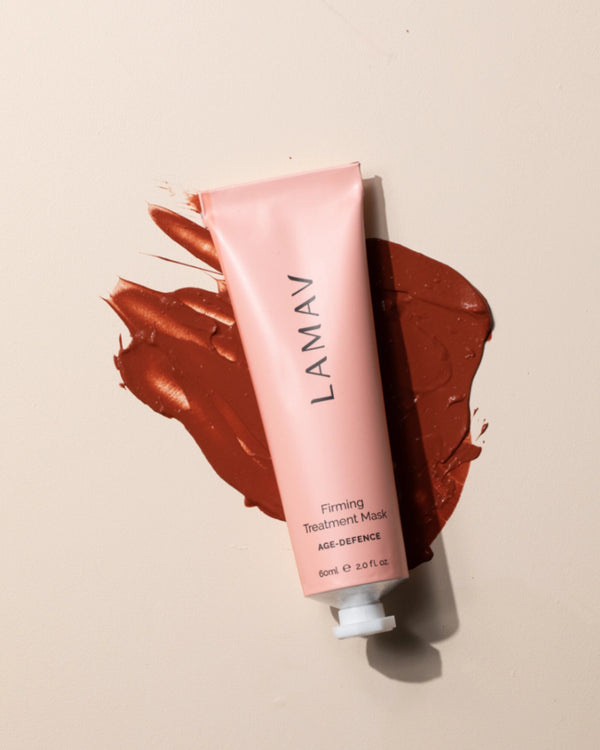 Firming Treatment Mask by LAMAV — pink tube resting on a thick smear of red clay mask | Purifies and firms the complexion