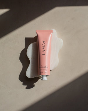 Firming Treatment Mask by LAMAV — pink tube on a white wavy stone with hard shadows | visibly tightens and smooths skin