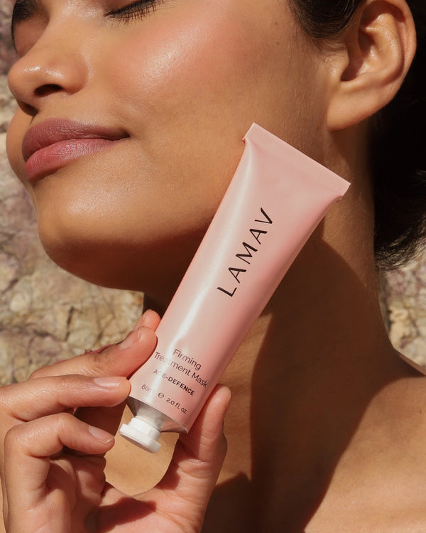 Firming Treatment Mask by LAMAV — woman holding the pink tube outdoors | Lifts and tightens mature skin