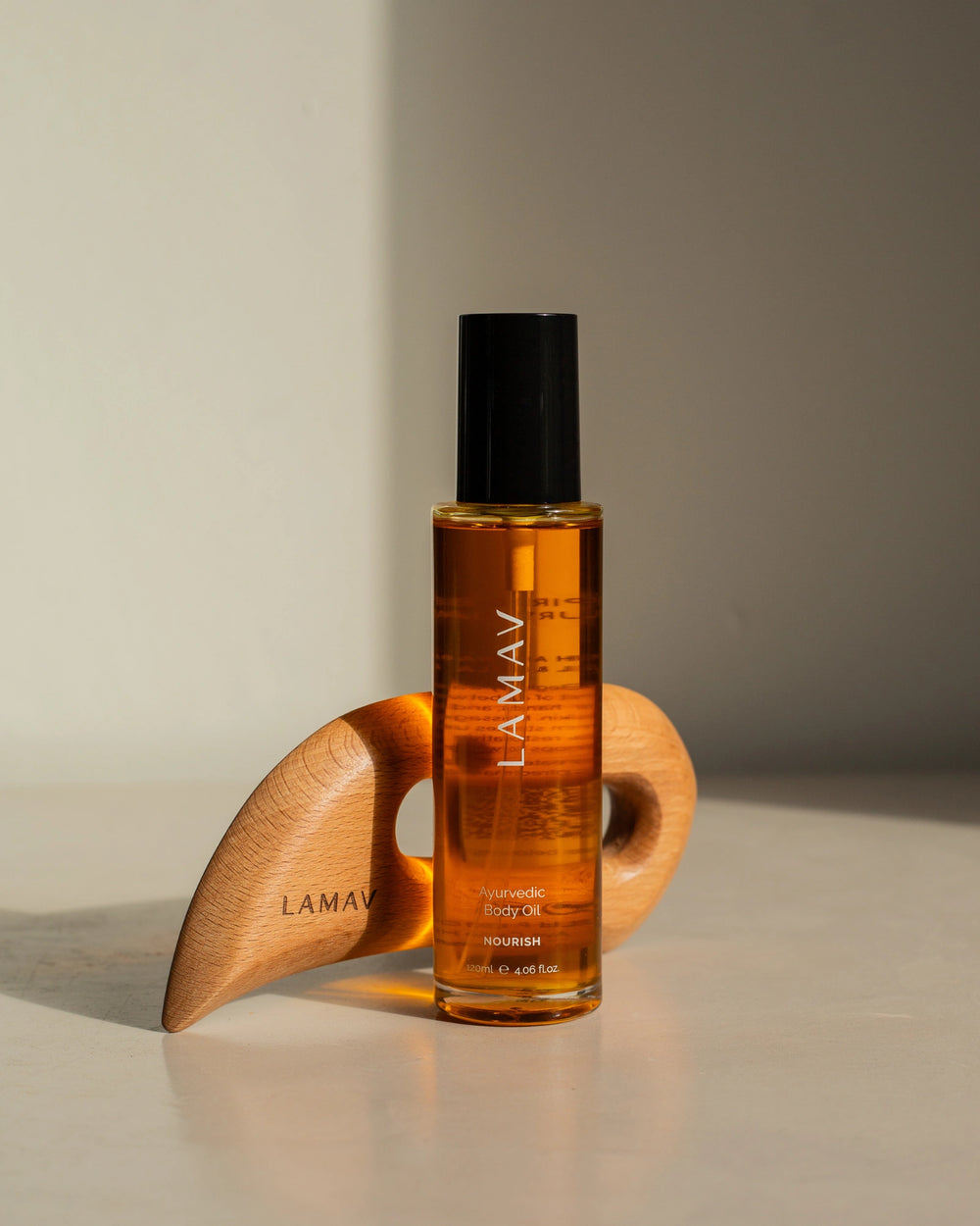 Full Body Bliss by LAMAV — wooden body sculpting tool and Ayurvedic body oil bottle beside award badge | body care set