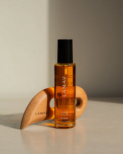 Full Body Bliss by LAMAV — standing oil bottle in front of wooden massage tool | deep hydration