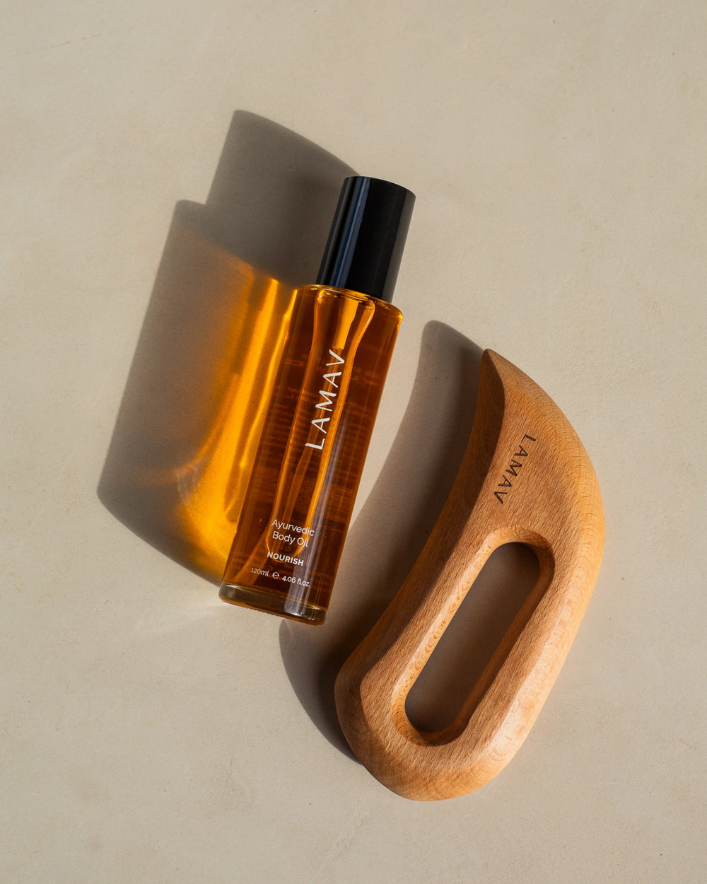 Full Body Bliss by LAMAV — wooden body sculpting tool and Ayurvedic body oil bottle beside award badge | body care set