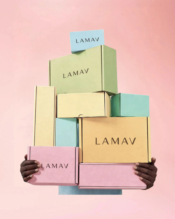 Gift Box by LAMAV — hands holding a tall stack of pastel boxes | beautifully packaged organic skincare gifts