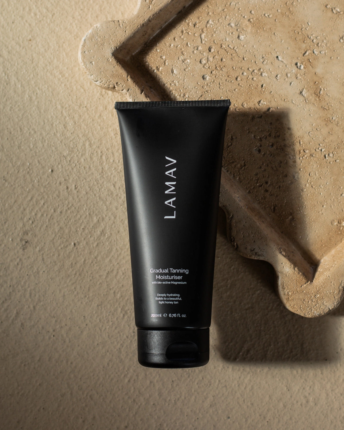 Gradual Tanning Moisturiser by LAMAV — 200ml black tube on stone | Hydrating light honey tan