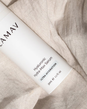 Hyaluronic Hydra-Max Serum by LAMAV — white bottle resting on soft linen fabric | Smooths fine lines and wrinkles