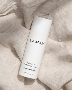 Hyaluronic Hydra-Max Serum by LAMAV — bottle lying flat on soft wrinkled fabric | Replenishes moisture levels