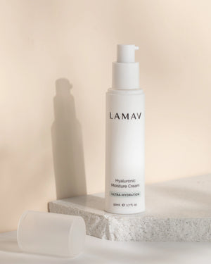 Hyaluronic Moisture Cream by LAMAV — pump bottle standing on a white stone slab | Locks in moisture for glowing skin